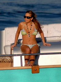 July 6, 2007: Mariah Carey shows off her newly toned bod, as she frolicked around Roberto Cavalli's yacht while on holiday in Salerno, Italy.  Carey played photographer as she took snaps of her friends on the front of the boat, then switched roles and posed for pictures of her own.  She then enjoyed a nice glass of wine before going swimming and jet skiing.
Credit: INFphoto.com  Ref: infit-03/rs