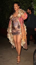 Santa Monica, CA  - *EXCLUSIVE*  - **WEB MUST CALL FOR PRICING**  Rihanna flashes huge diamond on THAT finger as she heads to Giorgio Baldi for dinner! The superstar who is expecting her first child with boyfriend A$AP was seen  heading to dinner at  Giorgio Baldi restaurant  with friends in Santa Monica on Tuesday night. The 34-year-old singer is wearing a cat print skin-tight curvy dress, high heeled sandals  and a colorful fur-lined coat. What stood out the most was the huge rock on her left ring finger as she adjusted her necklace. The superstar as been seen wearing the sparkler before but has started now wearing it on the finger typically reserved for an engagement ring. Shot on 03/22/22.  Pictured: Rihanna  BACKGRID USA 23 MARCH 2022  USA: +1 310 798 9111 / usasales@backgrid.com  UK: +44 208 344 2007 / uksales@backgrid.com  *UK Clients - Pictures Containing Children
Please Pixelate Face Prior To Publication*