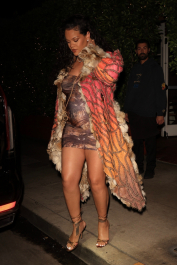 Santa Monica, CA  - *EXCLUSIVE*  - **WEB MUST CALL FOR PRICING**  Rihanna flashes huge diamond on THAT finger as she heads to Giorgio Baldi for dinner! The superstar who is expecting her first child with boyfriend A$AP was seen  heading to dinner at  Giorgio Baldi restaurant  with friends in Santa Monica on Tuesday night. The 34-year-old singer is wearing a cat print skin-tight curvy dress, high heeled sandals  and a colorful fur-lined coat. What stood out the most was the huge rock on her left ring finger as she adjusted her necklace. The superstar as been seen wearing the sparkler before but has started now wearing it on the finger typically reserved for an engagement ring. Shot on 03/22/22.  Pictured: Rihanna  BACKGRID USA 23 MARCH 2022  USA: +1 310 798 9111 / usasales@backgrid.com  UK: +44 208 344 2007 / uksales@backgrid.com  *UK Clients - Pictures Containing Children
Please Pixelate Face Prior To Publication*