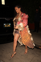 Santa Monica, CA  - *EXCLUSIVE*  - **WEB MUST CALL FOR PRICING**  Rihanna flashes huge diamond on THAT finger as she heads to Giorgio Baldi for dinner! The superstar who is expecting her first child with boyfriend A$AP was seen  heading to dinner at  Giorgio Baldi restaurant  with friends in Santa Monica on Tuesday night. The 34-year-old singer is wearing a cat print skin-tight curvy dress, high heeled sandals  and a colorful fur-lined coat. What stood out the most was the huge rock on her left ring finger as she adjusted her necklace. The superstar as been seen wearing the sparkler before but has started now wearing it on the finger typically reserved for an engagement ring. Shot on 03/22/22.  Pictured: Rihanna  BACKGRID USA 23 MARCH 2022  USA: +1 310 798 9111 / usasales@backgrid.com  UK: +44 208 344 2007 / uksales@backgrid.com  *UK Clients - Pictures Containing Children
Please Pixelate Face Prior To Publication*